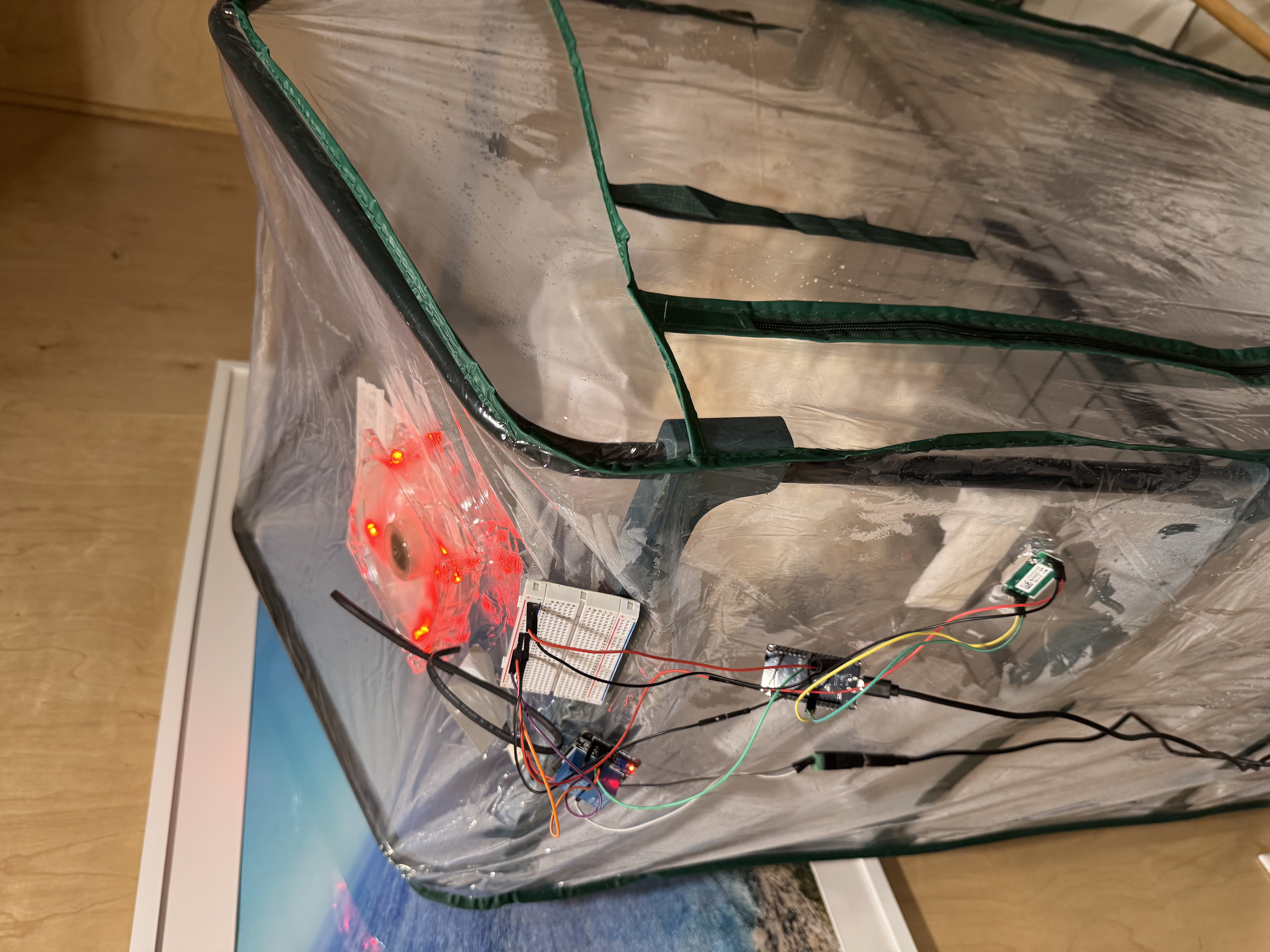 ESP32-based IoT system mounted on a transparent mushroom grow tent